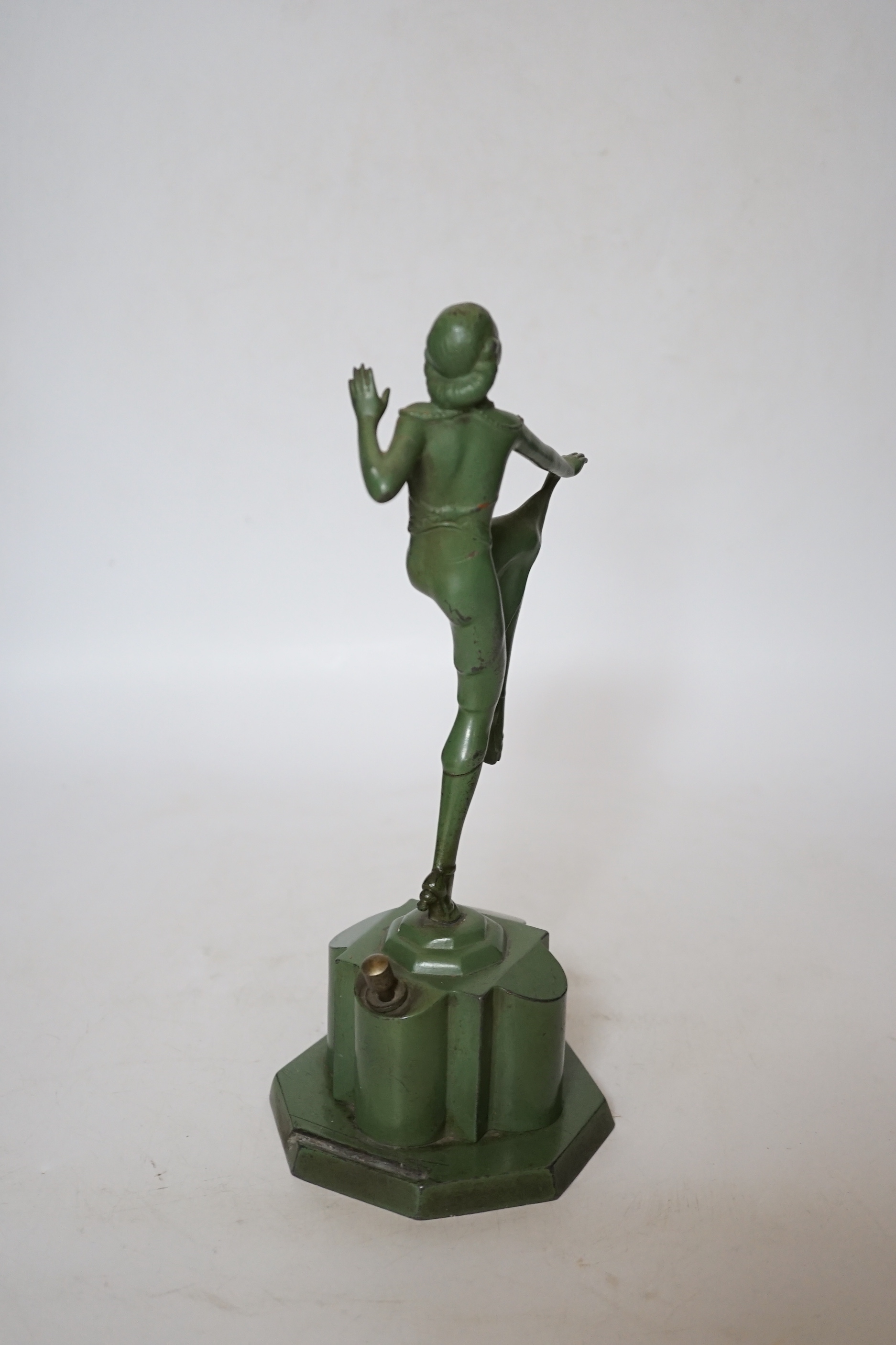 An Art Deco match striker in the form of a dancing woman, with patinated green finish, 25cm
